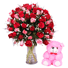 Red and Pink Roses in a vase and a teddy