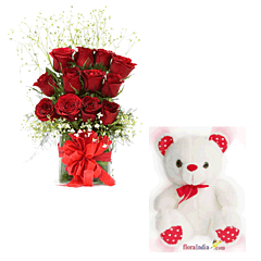 Red Roses in a glass vase with Teddy Bear
