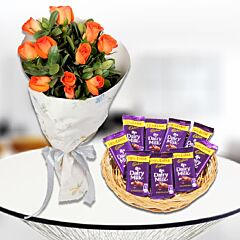 Orange Roses with Cadbury Dairy Milk Chocolate Bars in a Basket