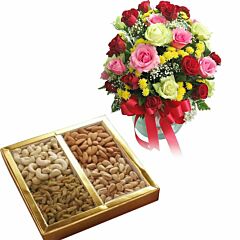 An arrangement of mix color Roses in a vase with Assorted Dry Fruit Box.