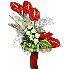 Arrangement of white carnations and red anthuriums in a Vase