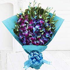 One Sided bouquet of Blue orchids in a blue paper