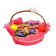 Assorted Chocolate bars with ball candles in a handle basket