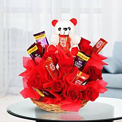 Arrangement of Red Roses, Kitkat, Cadbury Dairy Milk with a teddy